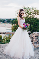 Fototapeta na wymiar Beautiful bride in a light and airy wedding dress