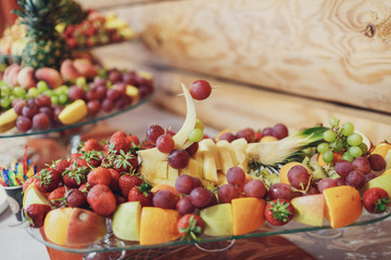 Plate with grape, bananas and pineapple