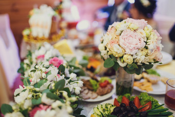 Wedding bouquet stands in the vase on a table