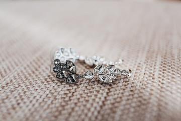 Crystal earrings lie on the chair