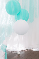 White and blue balloons hang over the floor