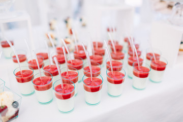 Glasses with cold desserts and strawberries