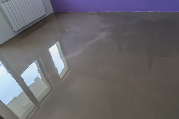 Interior of house under construction. Floor covering with self l