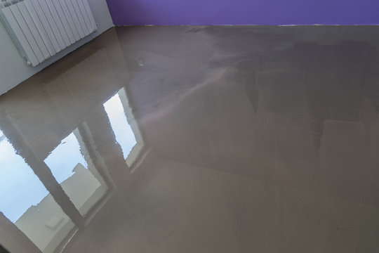 Interior of house under construction. Floor covering with self l
