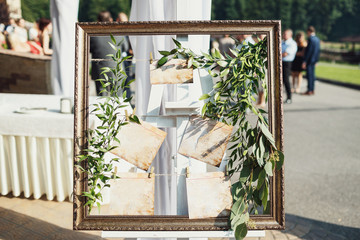 Card pinned to the rope and surrounded with green leaves