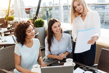 Fototapeta premium Delighted blonde woman holding a document