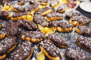 Little eclairs covered with chocolate
