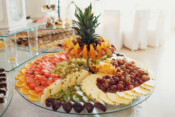 Sliced pineapples, kiwis, oranges and other fruits