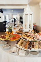 Delicious fancy cakes made of chocolate and cheese stand on the table