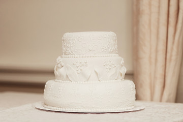 White wedding cake covered with icing