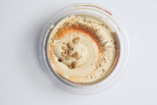 Hummus with cedar nuts in the jar and fresh pita