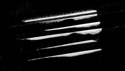 Cocaine lines isolated on black background 