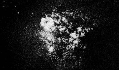 White powder exploding isolated on black background