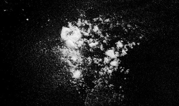 White powder exploding isolated on black background