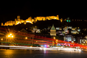 Fototapeta na wymiar Tbilisi, Georgia - July 15, 2017: Night view of Tbilisi city with lots of traffic lights. View of the Old City in Tbilisi at night. Georgia Country