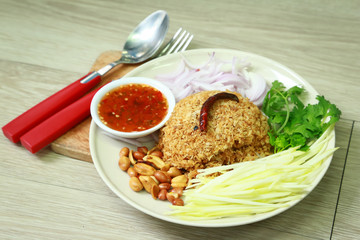 Thai Cuisine and Food, Thai Traditional Crispy Catfish Salad Served With Green Oak, Shredded Green Mango, Red Onion, Cabbage, Chili, Peanut and Spicy Sauce