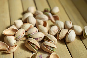 Pistachio nuts on bamboo table. Horizontal image.