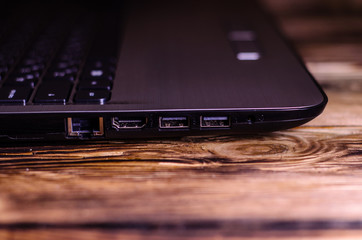 Modern laptop on rustic wooden table