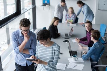 Two Business People Working With Tablet in office