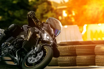 Foto op Canvas man riding sport motorcycle on racing track © stockphoto mania