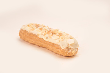 Close up of white eclair with nuts