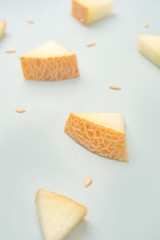 Pieces of melon on blue background
