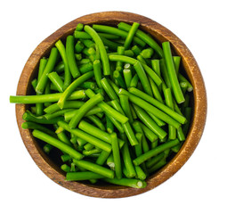 Wooden bowl with green pods, isolated on white background