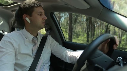Man using hands free device to make a call in car