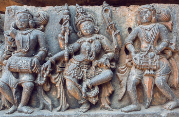 Example of ancient Indian architecture and traditional style relief, with drummer musicians and dancing Hindu goddess inside the 12th century Hoysaleshwara temple in Halebidu, India