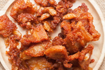 Fried Pork with Garlic Pepper on wooden plate