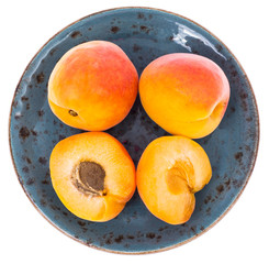 Sweet ripe apricots on blue vintage plate