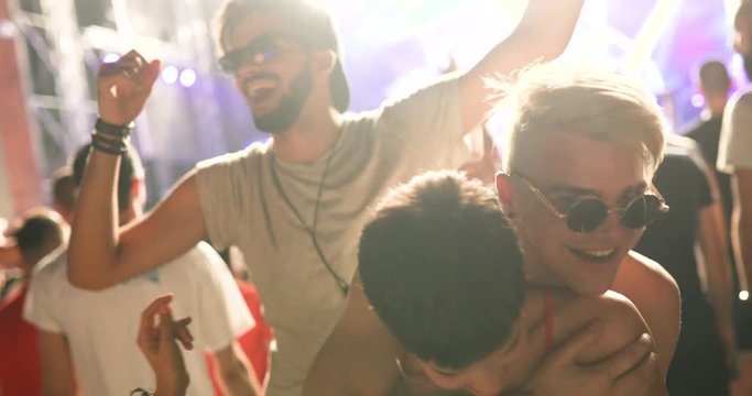 Group of friends having fun and dancing at concert