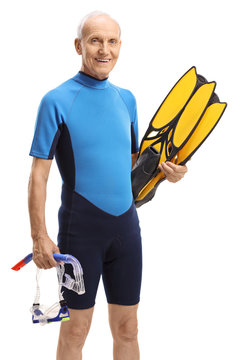 Elderly man in a wetsuit with snorkeling equipment