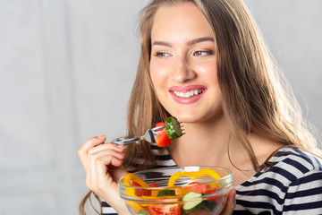 young beautiful woman eating healthy food - salad