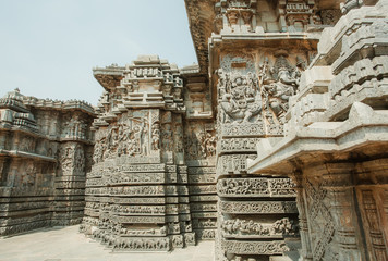 Ornate corner of the 12th century Hoysaleshwara temple with portraits of Ganesha and Lord Brahma in ancient city Halebidu, India