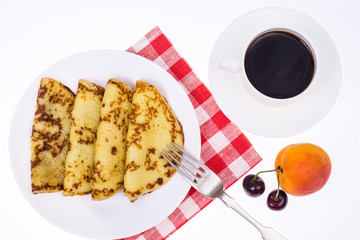 Crispy thin pancakes on plate, light background