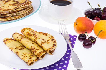 Crispy thin pancakes on plate, light background