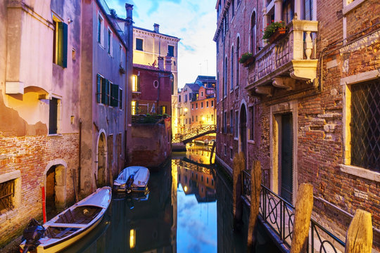 Venetian canal at sunset time.