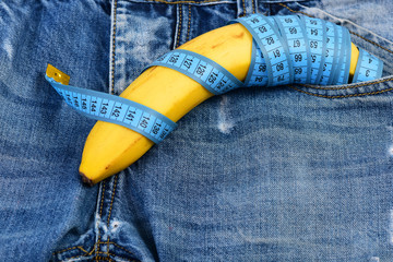 Mens denim pants with banana imitating male genitals, close up