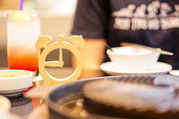 Wooden clock model put on table of food, food time, lunch time, eating time concept