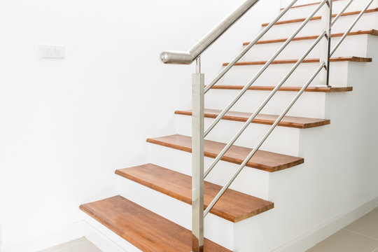 interior design staircase concrete top  wooden stainless steel railing in the home