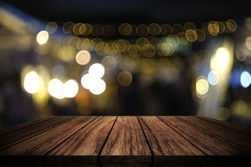 wooden table in front of abstract blurred light