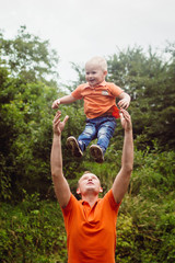 Dad has fun with his son in orange t-shirt