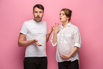 The funny surprised handsome man and his beautiful pregnant wife's tummy