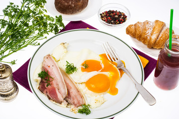 Hearty breakfast with bacon and fried eggs