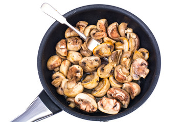 Halves of champignons fried in frying pan