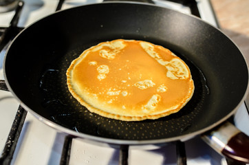 Cooking pancakes in a frying pan.