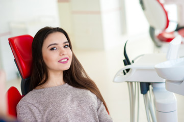 Fototapeta premium Beautiful girl smiles in the dental chair.