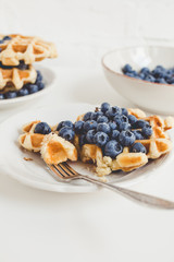 composition of freshly baked waffles and blueberries for breakfast
