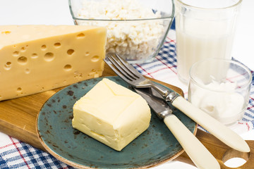 Protein products: cheese, butter, cottage, milk, eggs on white b